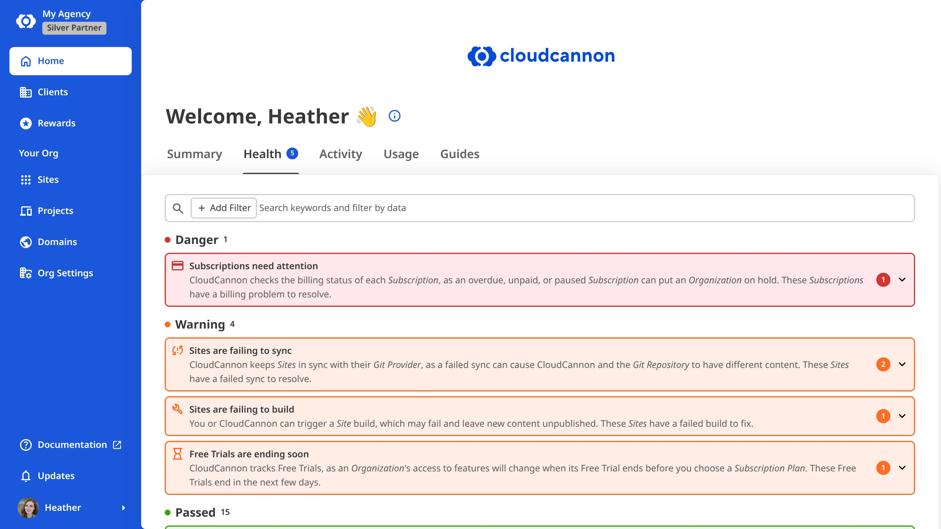A screenshot of the Health tab on a Partner Organization's Organization Home page shows health checks grouped under Danger, Warning, and Passed.
