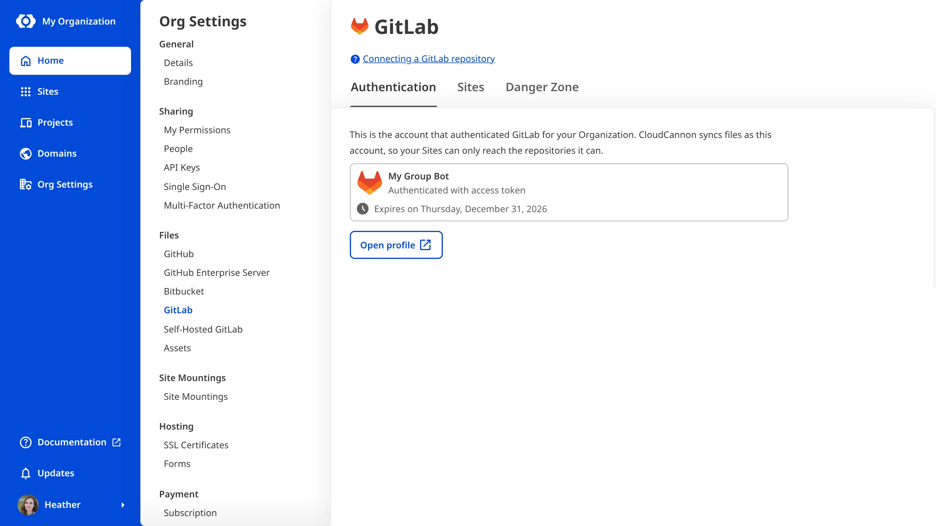 A screenshot of the Authentication tab on the GitLab page under Org Settings shows a group access token bot account with its expiry date and an Open profile button.