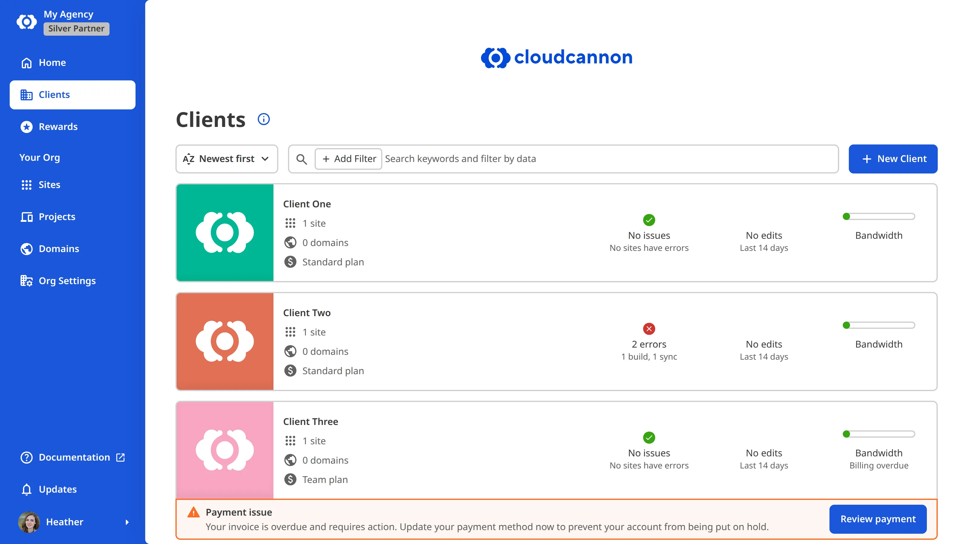 The Client Organizations Browser A screenshot of the Client Organizations Browser in a Partner Organization shows four Client Organizations as cards, each listing its Sites and domains counts, Subscription Plan, and issue status, with the New Client button above the list and the Clients link in the App Sidebar.